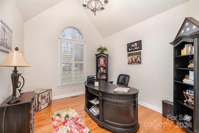 office featuring a notable chandelier, vaulted ceiling, and hardwood / wood-style flooring