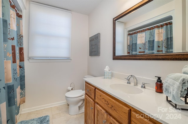 bathroom with tile patterned floors, vanity, and toilet