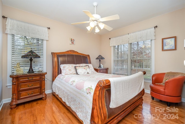 bedroom with multiple windows, light wood-type flooring, and ceiling fan