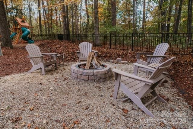 view of patio / terrace featuring a playground and an outdoor fire pit