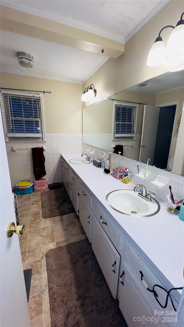 bathroom with vanity, tile walls, and ornamental molding