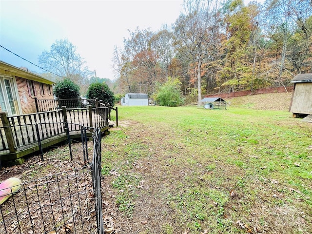 view of yard with a deck and an outdoor structure