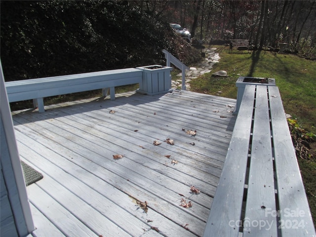 wooden deck featuring a yard