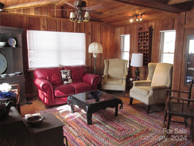 living room featuring vaulted ceiling, ceiling fan, and wooden ceiling