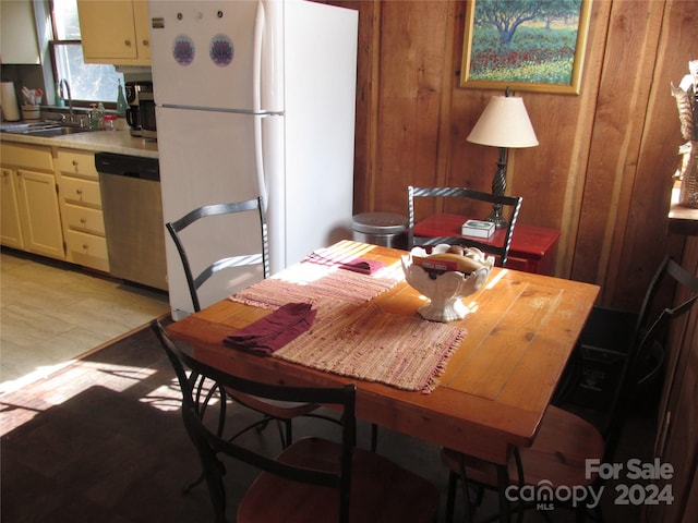 dining room with wood walls and sink