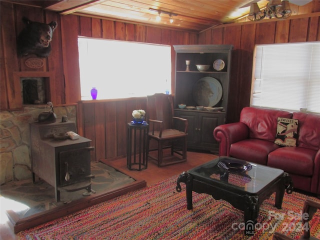 living room featuring wood walls, wooden ceiling, and vaulted ceiling