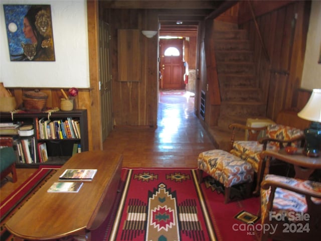 interior space with wood-type flooring and wooden walls