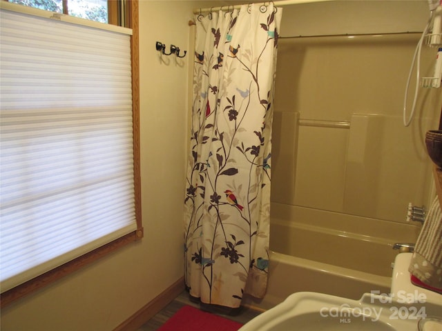 bathroom with shower / bath combination with curtain