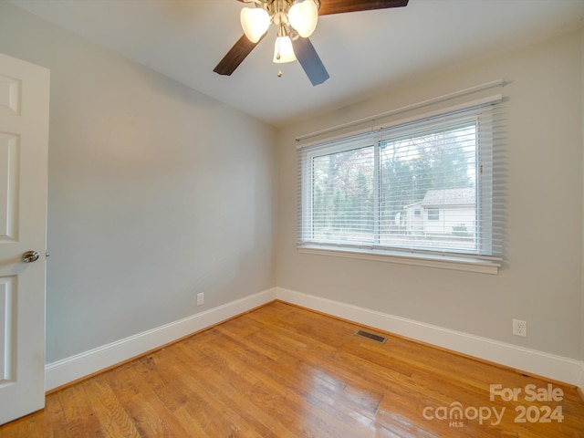 spare room with light hardwood / wood-style flooring and ceiling fan