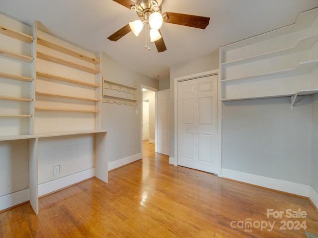 unfurnished bedroom with a closet, hardwood / wood-style flooring, and ceiling fan