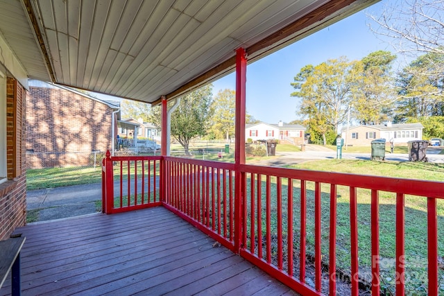 wooden terrace featuring a yard