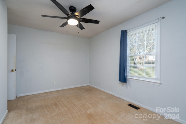 carpeted empty room with ceiling fan