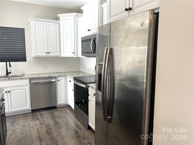 kitchen featuring white cabinetry, stainless steel appliances, and dark hardwood / wood-style floors