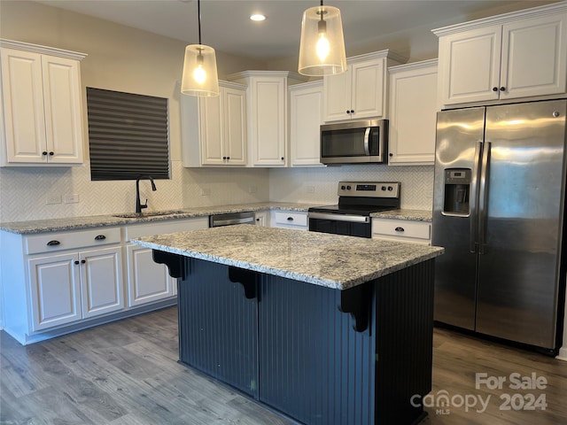 kitchen with white cabinetry, appliances with stainless steel finishes, and light hardwood / wood-style flooring