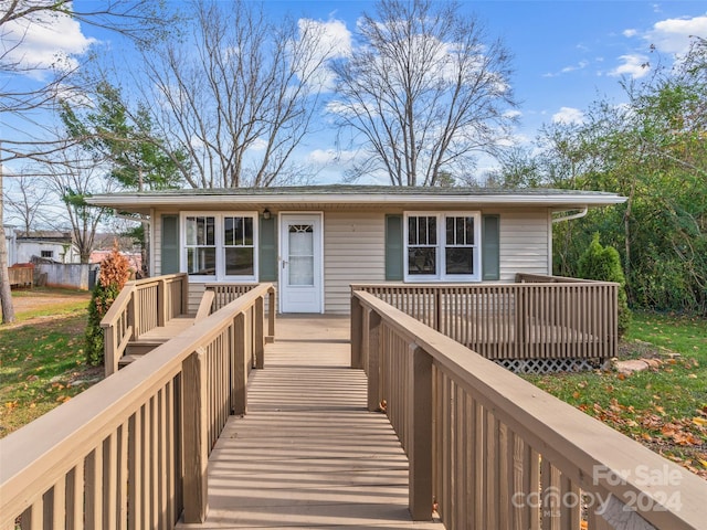 view of front facade with a wooden deck