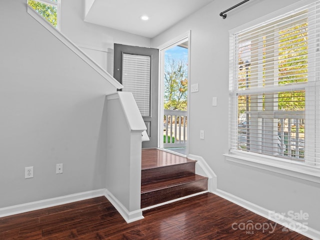 staircase featuring recessed lighting, wood finished floors, and baseboards