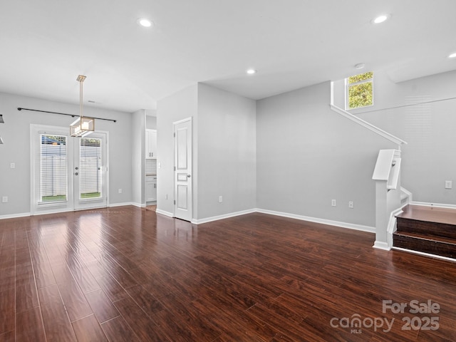 unfurnished living room with recessed lighting, stairway, plenty of natural light, and wood finished floors