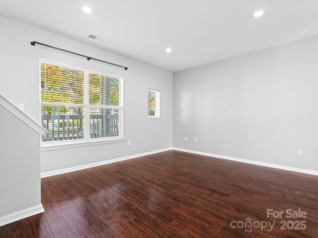 empty room featuring visible vents, recessed lighting, baseboards, and wood finished floors