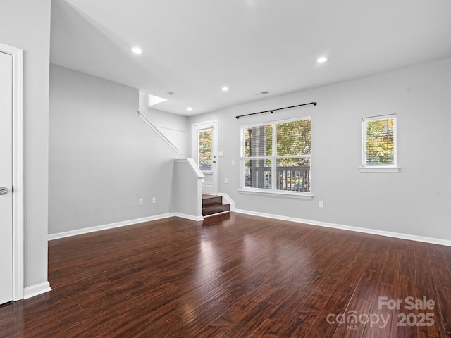 spare room featuring recessed lighting, stairway, baseboards, and wood finished floors