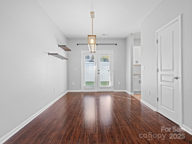 empty room featuring french doors, baseboards, visible vents, and wood finished floors