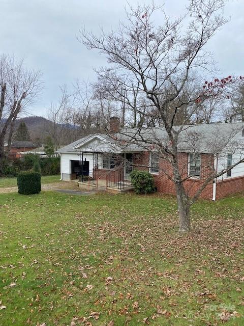 exterior space with a mountain view and a yard