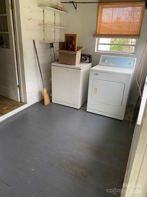 washroom featuring dark hardwood / wood-style flooring and washing machine and dryer