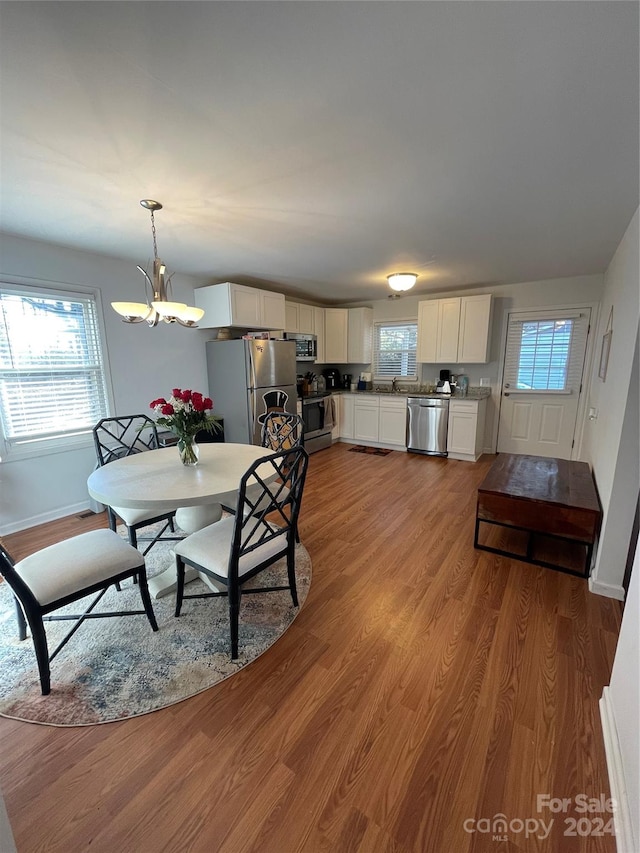 dining room featuring a chandelier and light hardwood / wood-style floors