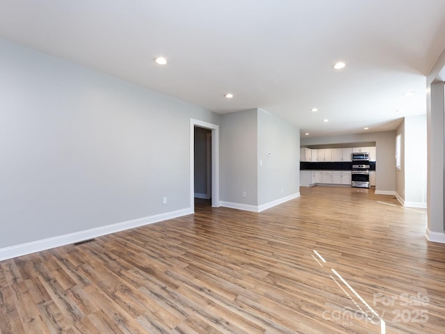 unfurnished living room with light hardwood / wood-style flooring