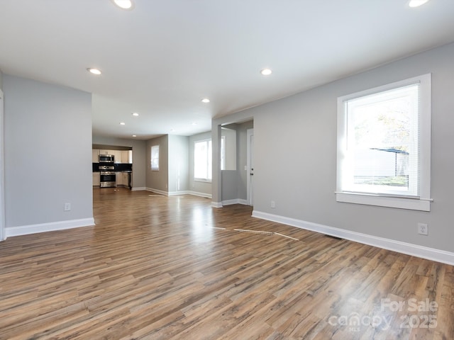 unfurnished living room with wood-type flooring