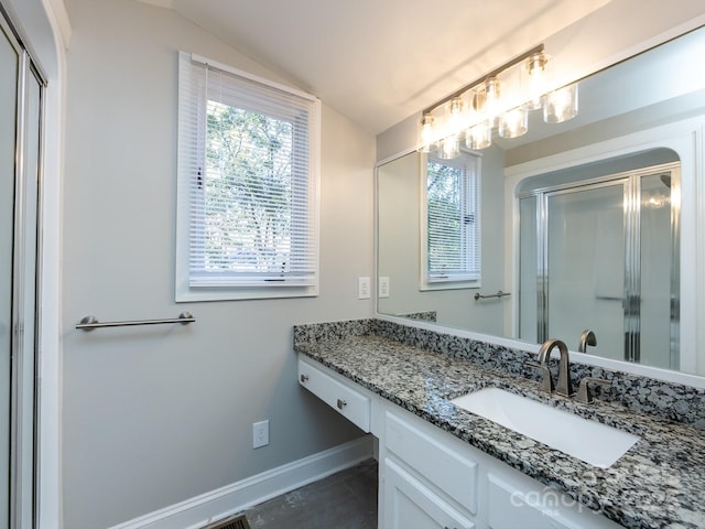 bathroom with tile patterned floors, vanity, vaulted ceiling, and an enclosed shower