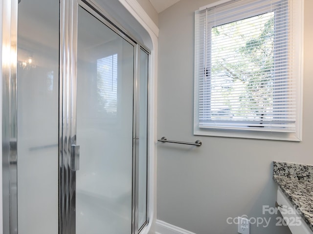 bathroom with vanity and a shower with shower door