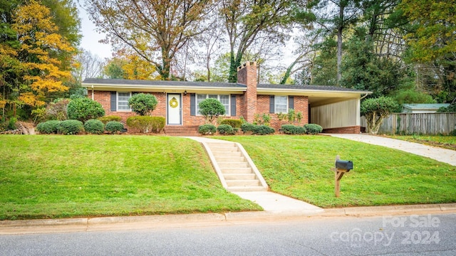 ranch-style home featuring a front lawn and a carport