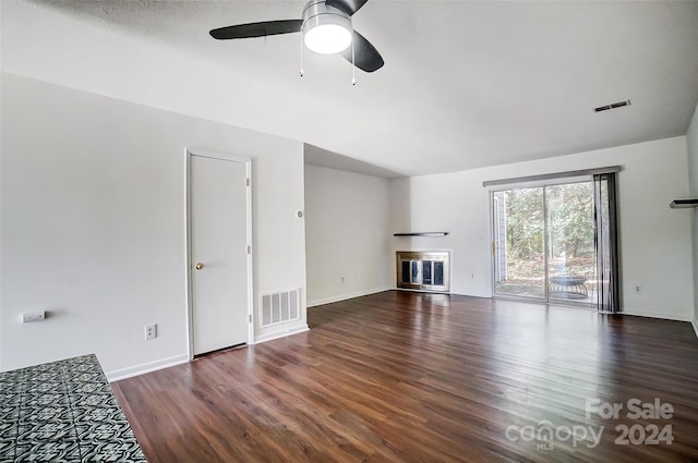 unfurnished living room with dark hardwood / wood-style flooring and ceiling fan