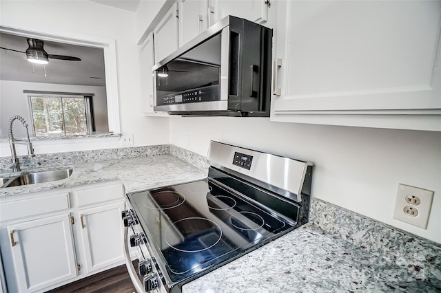 kitchen with ceiling fan, sink, dark hardwood / wood-style flooring, white cabinets, and appliances with stainless steel finishes