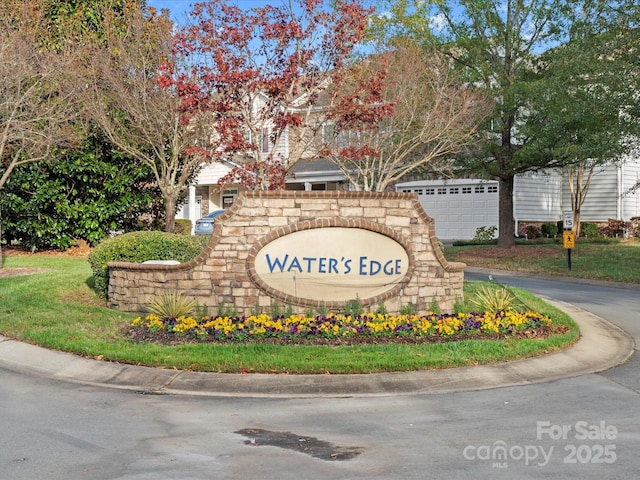 community / neighborhood sign featuring a garage