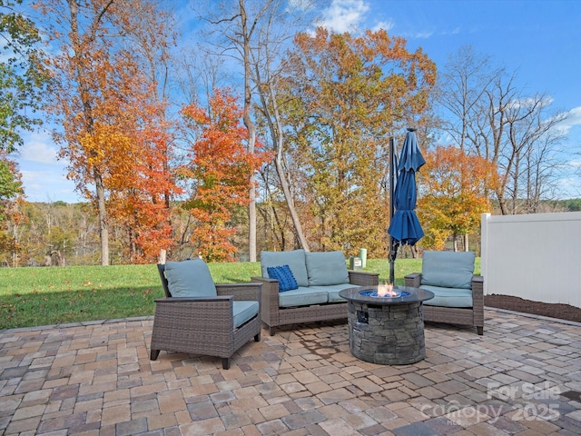 view of patio featuring an outdoor living space with a fire pit