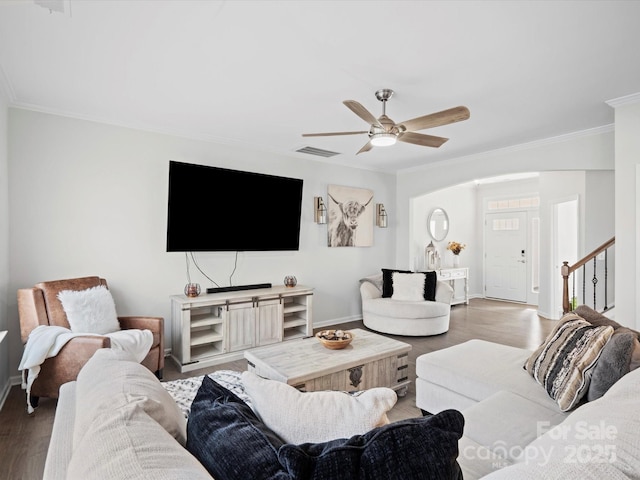 living room with ceiling fan, ornamental molding, and wood-type flooring