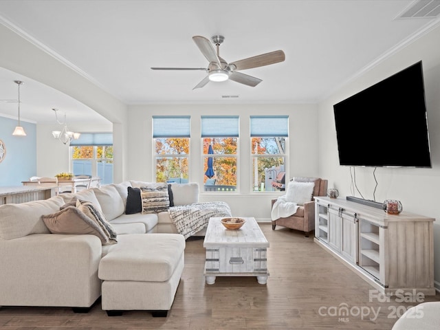 living room with crown molding and light wood-type flooring