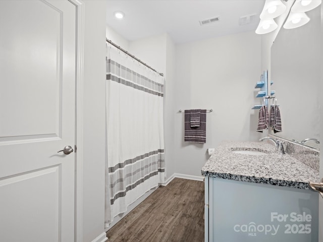 bathroom with wood-type flooring and vanity