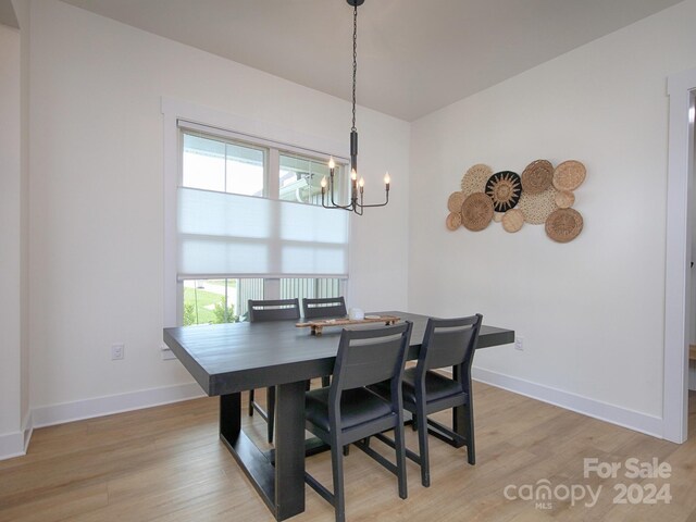 dining room with an inviting chandelier and light wood-type flooring