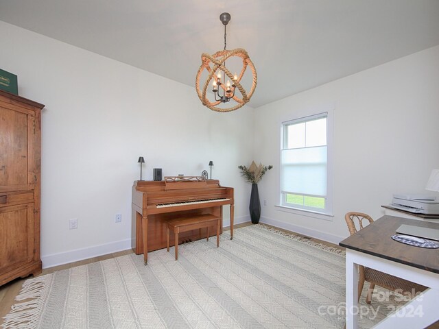 misc room featuring a chandelier and light wood-type flooring