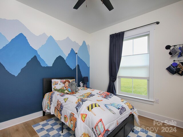 bedroom with hardwood / wood-style floors and ceiling fan