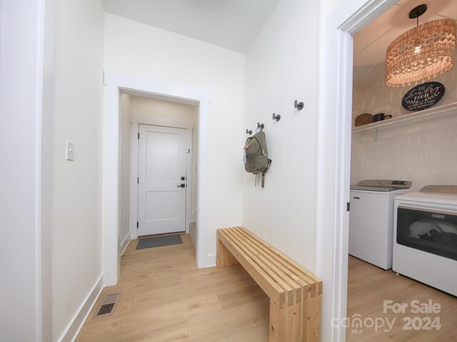 laundry area featuring washer and dryer and light wood-type flooring