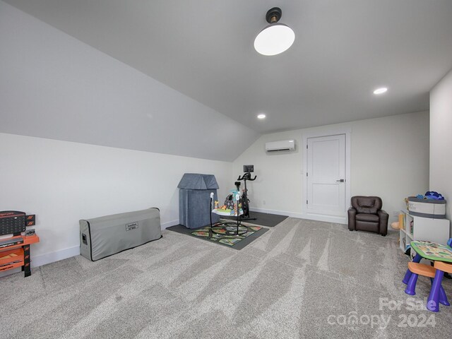 interior space with carpet flooring, vaulted ceiling, and a wall unit AC