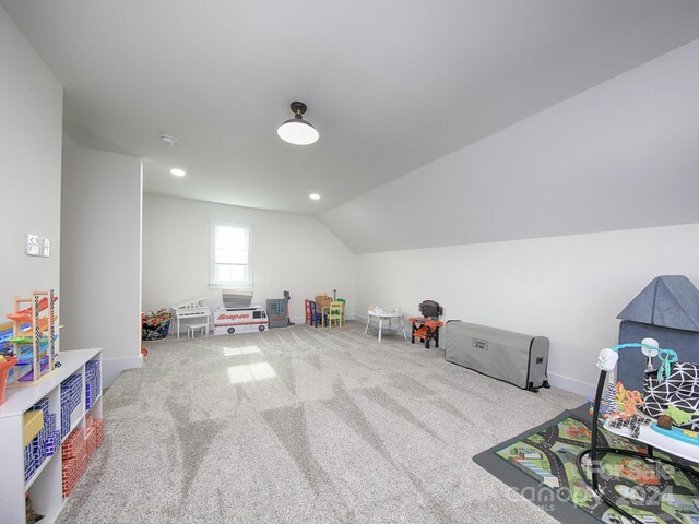 game room featuring carpet flooring and vaulted ceiling