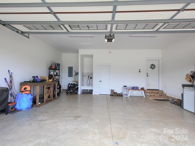 garage with electric panel and a garage door opener