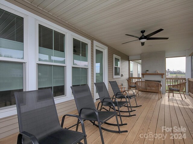 wooden deck featuring ceiling fan