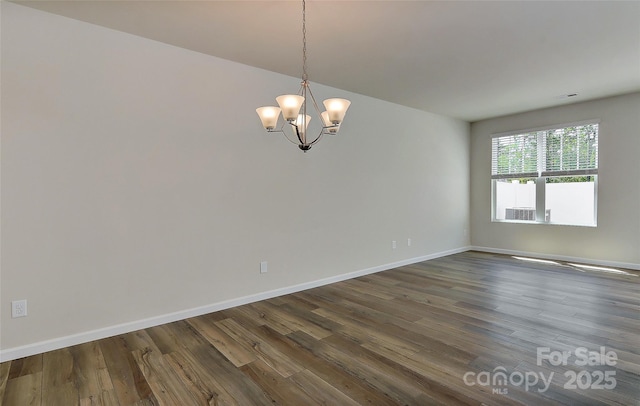 unfurnished room with a chandelier and hardwood / wood-style floors