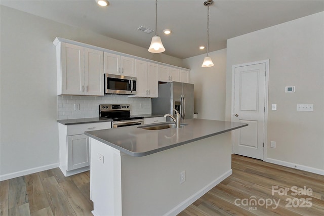 kitchen with white cabinetry, sink, and appliances with stainless steel finishes