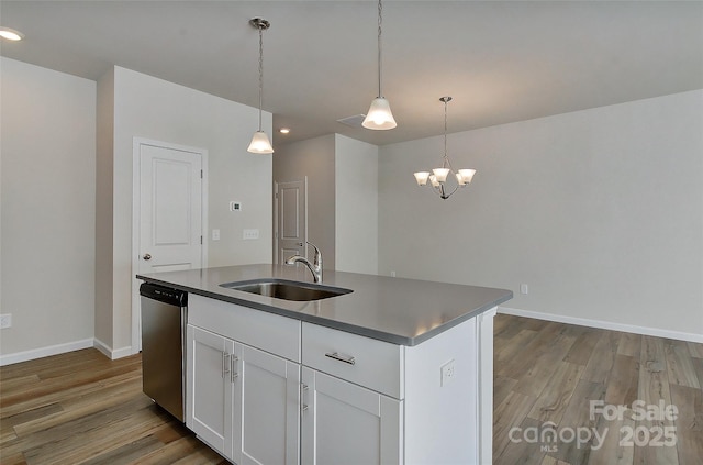 kitchen featuring white cabinetry, sink, stainless steel dishwasher, an island with sink, and pendant lighting